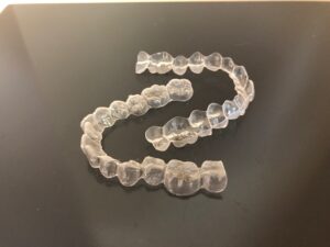 Actual photo of a pair of Invisalign clear aligners