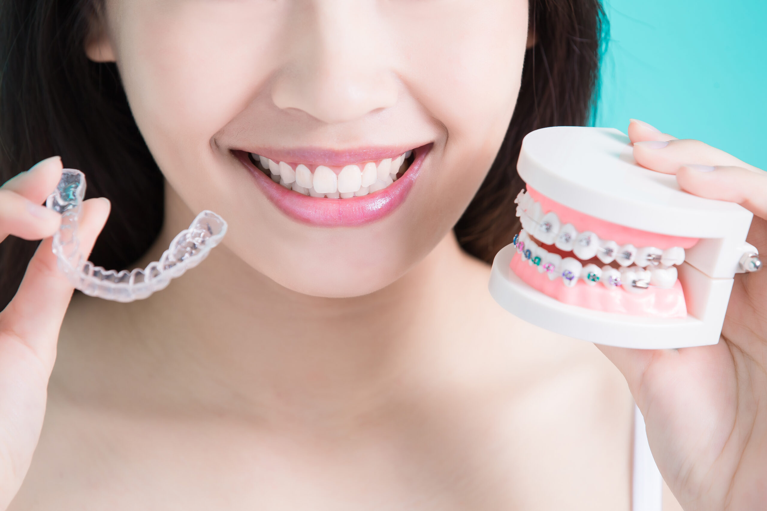 Woman making a choice to go with Invisalign or braces
